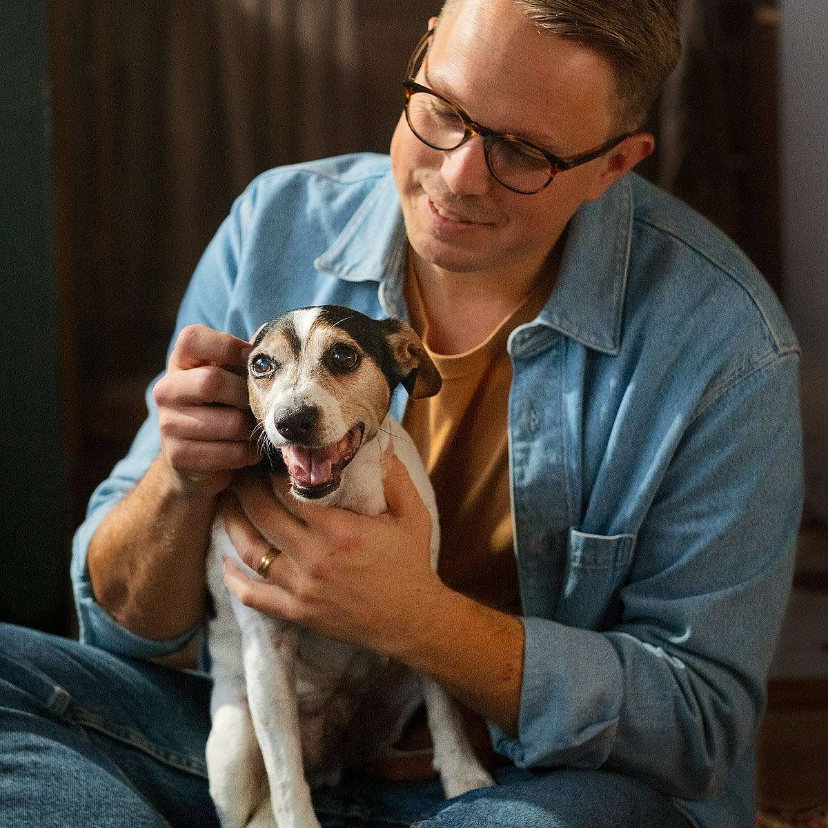 Man and dog cuddling.